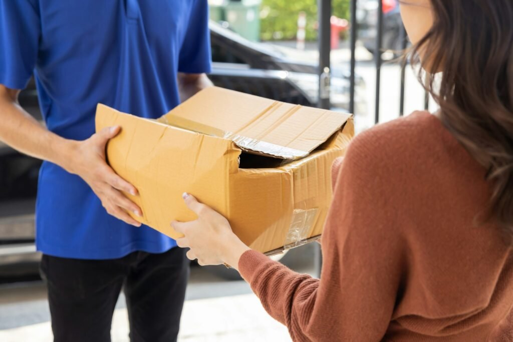 Delivery Man with Damaged Parcel Box Delivered to Customer