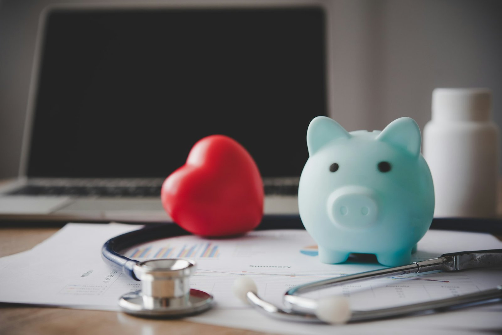 Medical Insurance Concept With Piggy Bank And Stethoscope On Wooden Desk